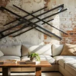 Cozy living room with industrial metal art sculpture on brick wall, beige sofa, wooden coffee table, and natural light illuminating the space.